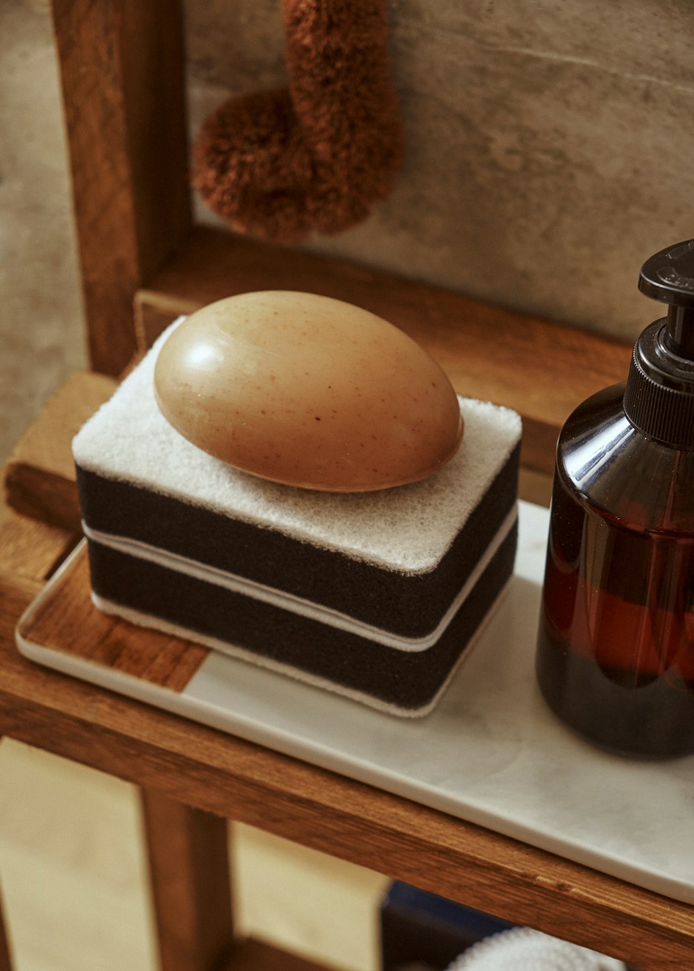 a bottle of soap and a soap dish on a counter