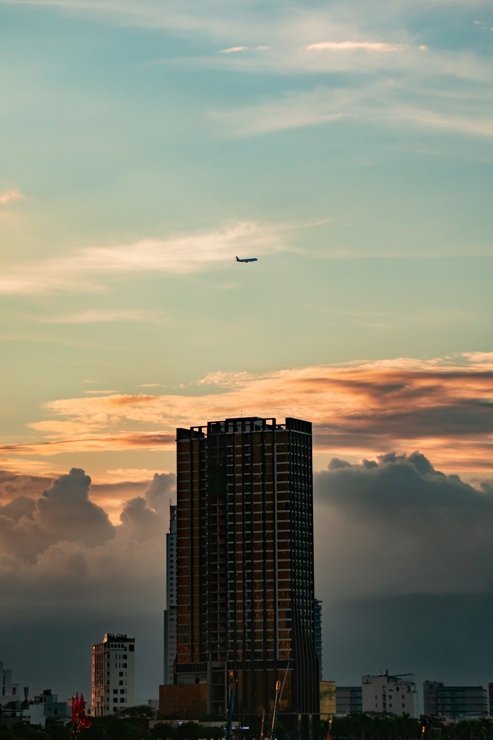 a plane flying in the sky over a city