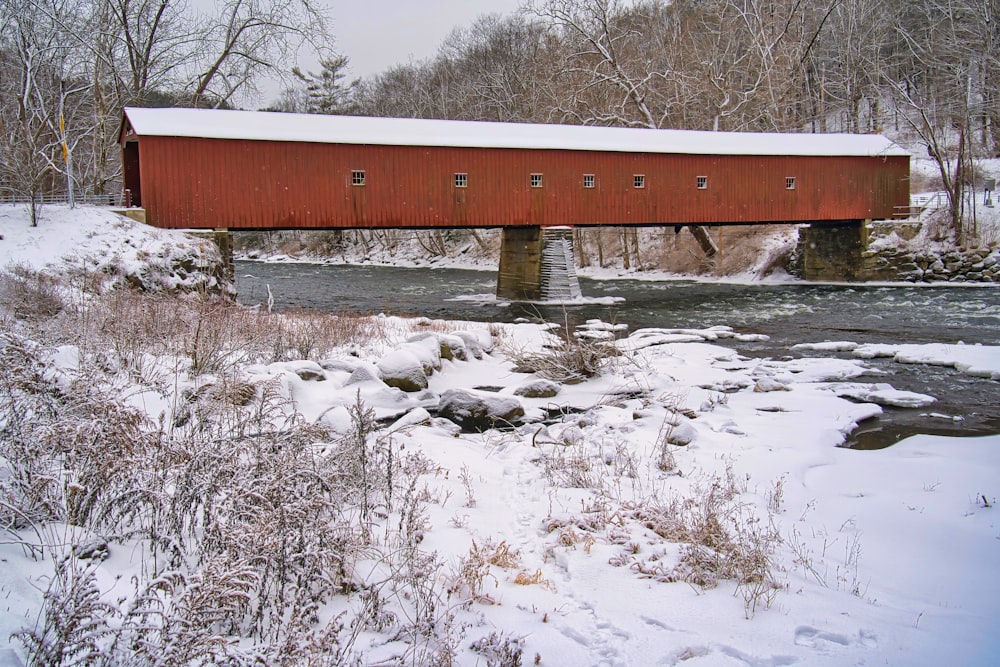 a red covered bridge over a small stream