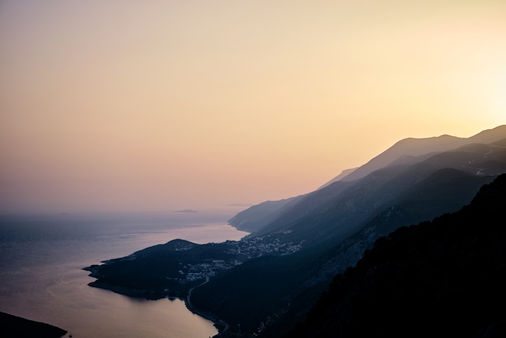 a view of a body of water with mountains in the background