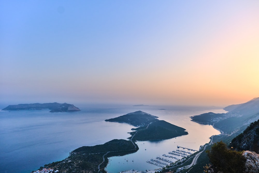 a view of a bay and mountains at sunset