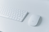 An elegant wireless keyboard on a modern workspace desk.