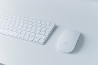 A sleek wireless keyboard on a modern desk setup.