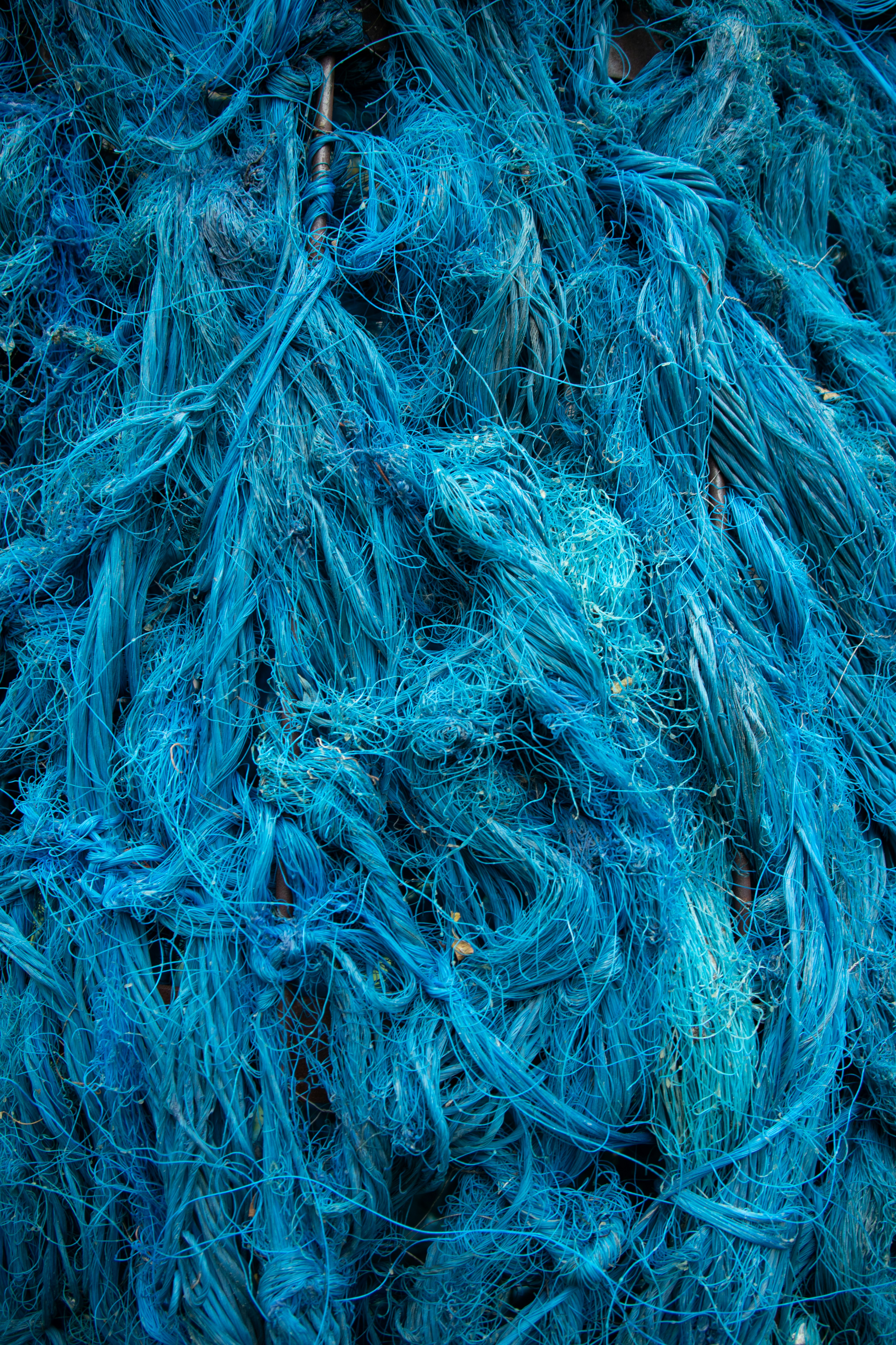 青い漁網の山が積み重なっている