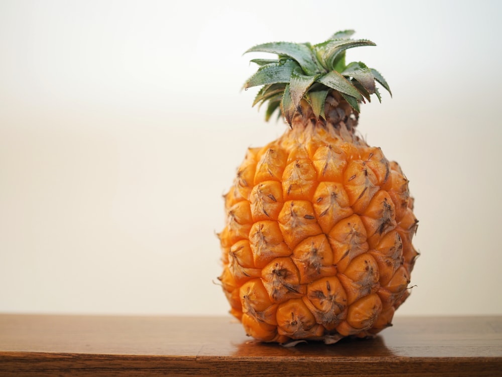 a pineapple sitting on top of a wooden table