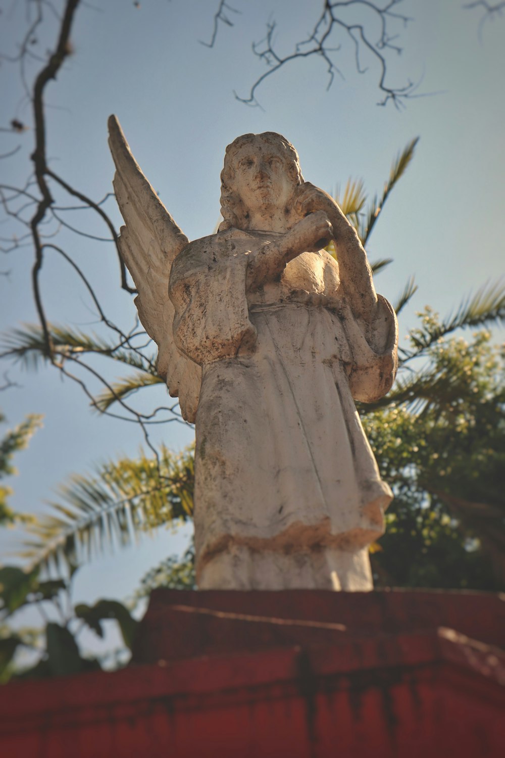 a statue of an angel on top of a building