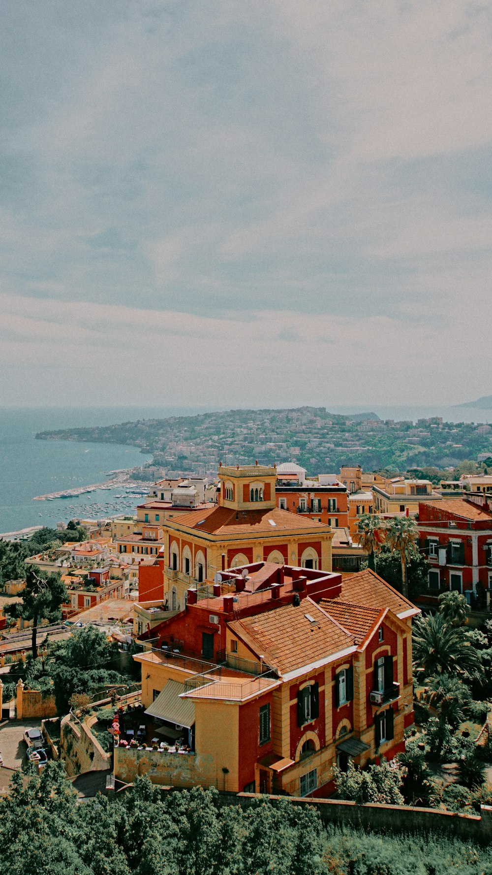 a view of a town with a body of water in the background