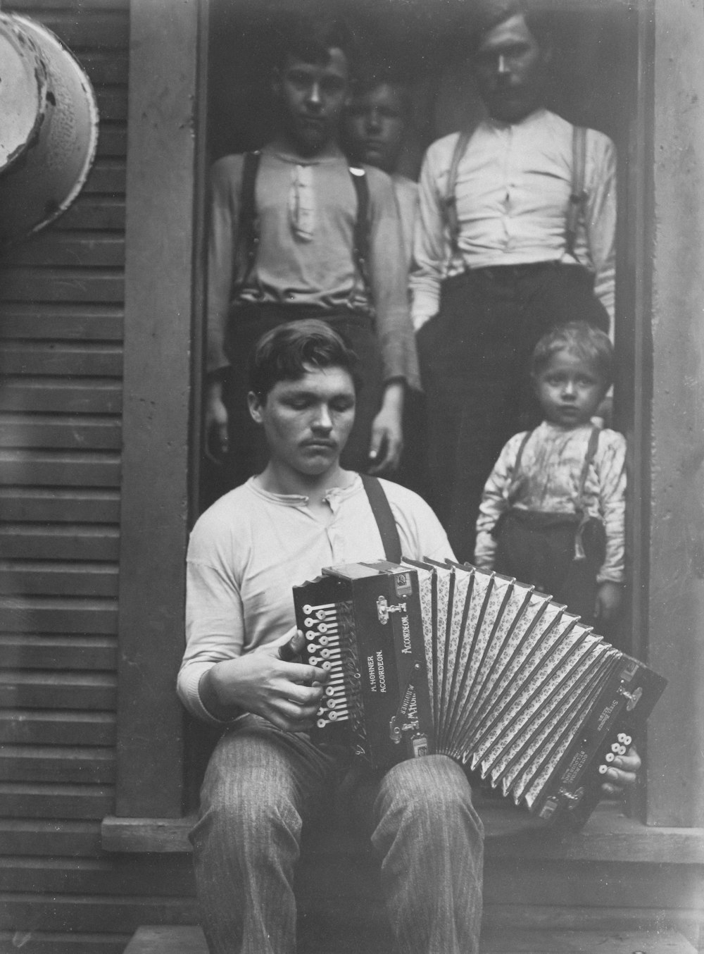 an old photo of a man playing an accordion