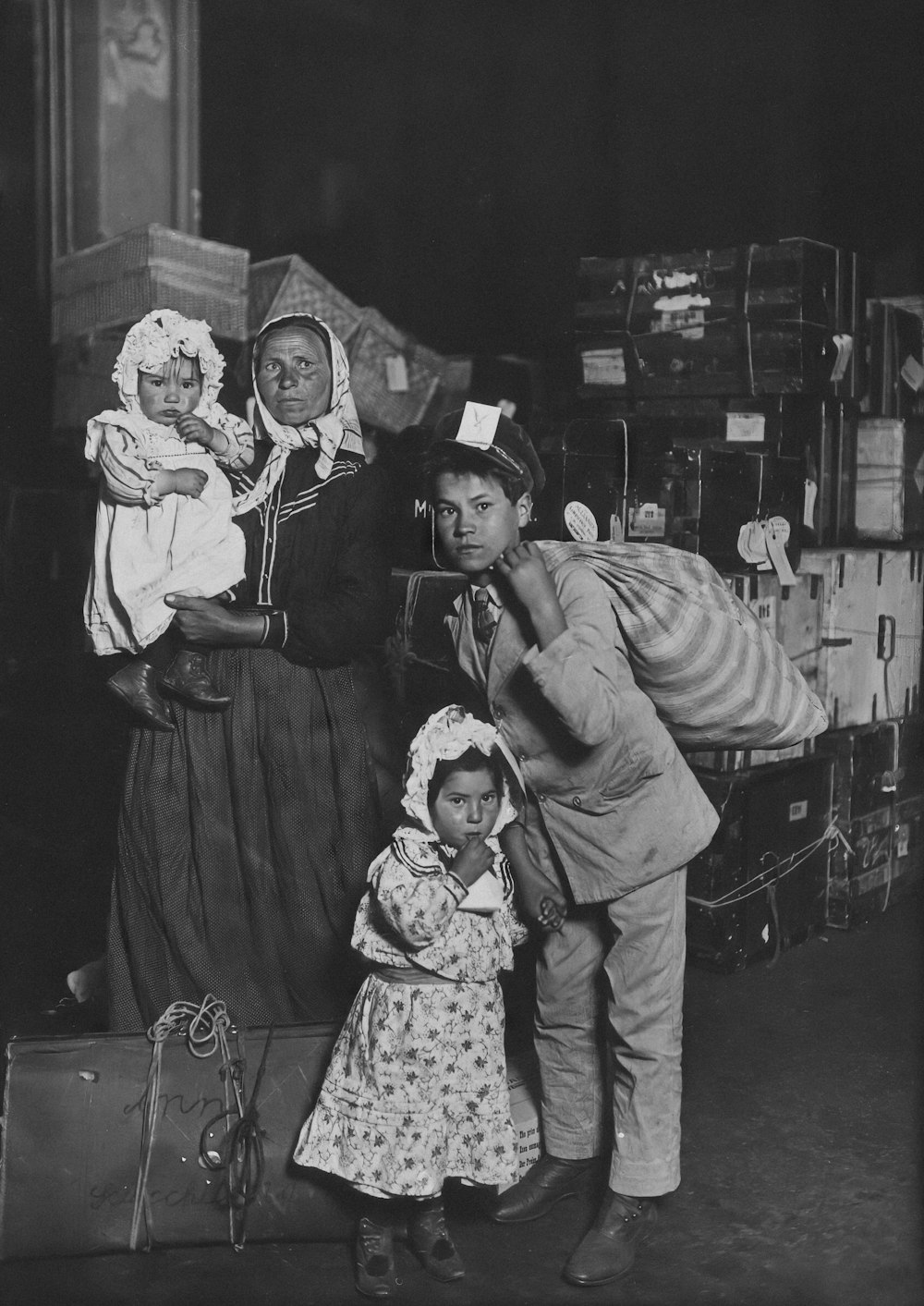 an old photo of a woman and two children