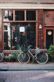 a couple of bikes parked next to each other in front of a building