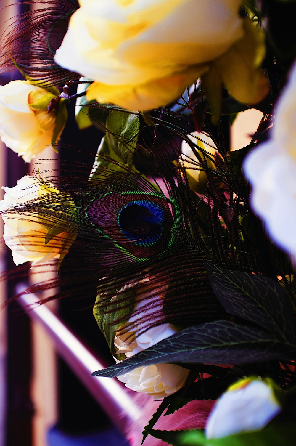 a close up of a peacock's feathers and flowers