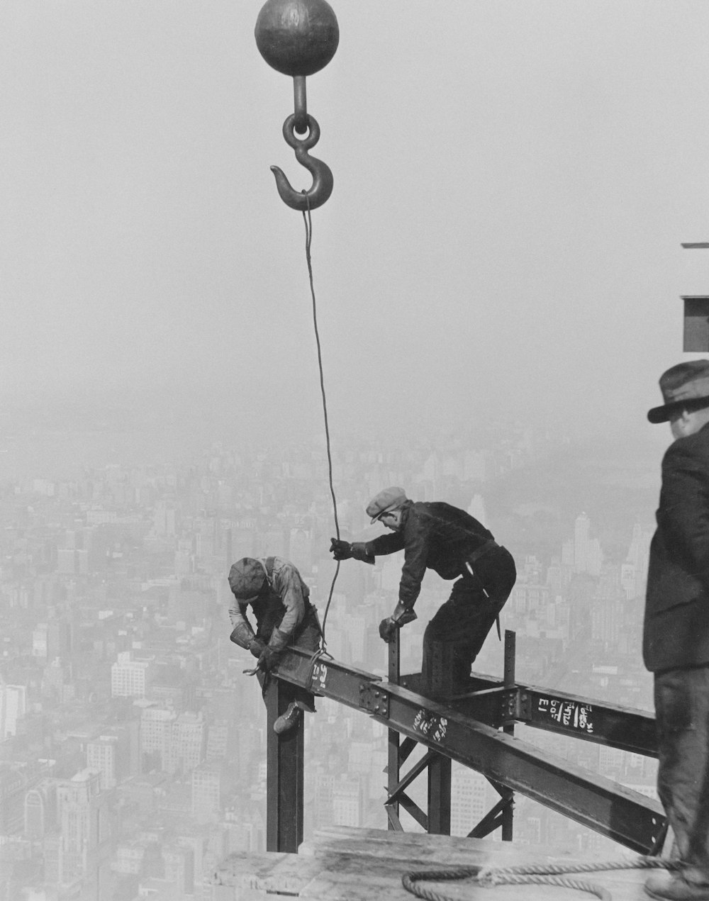 a group of men standing on top of a building