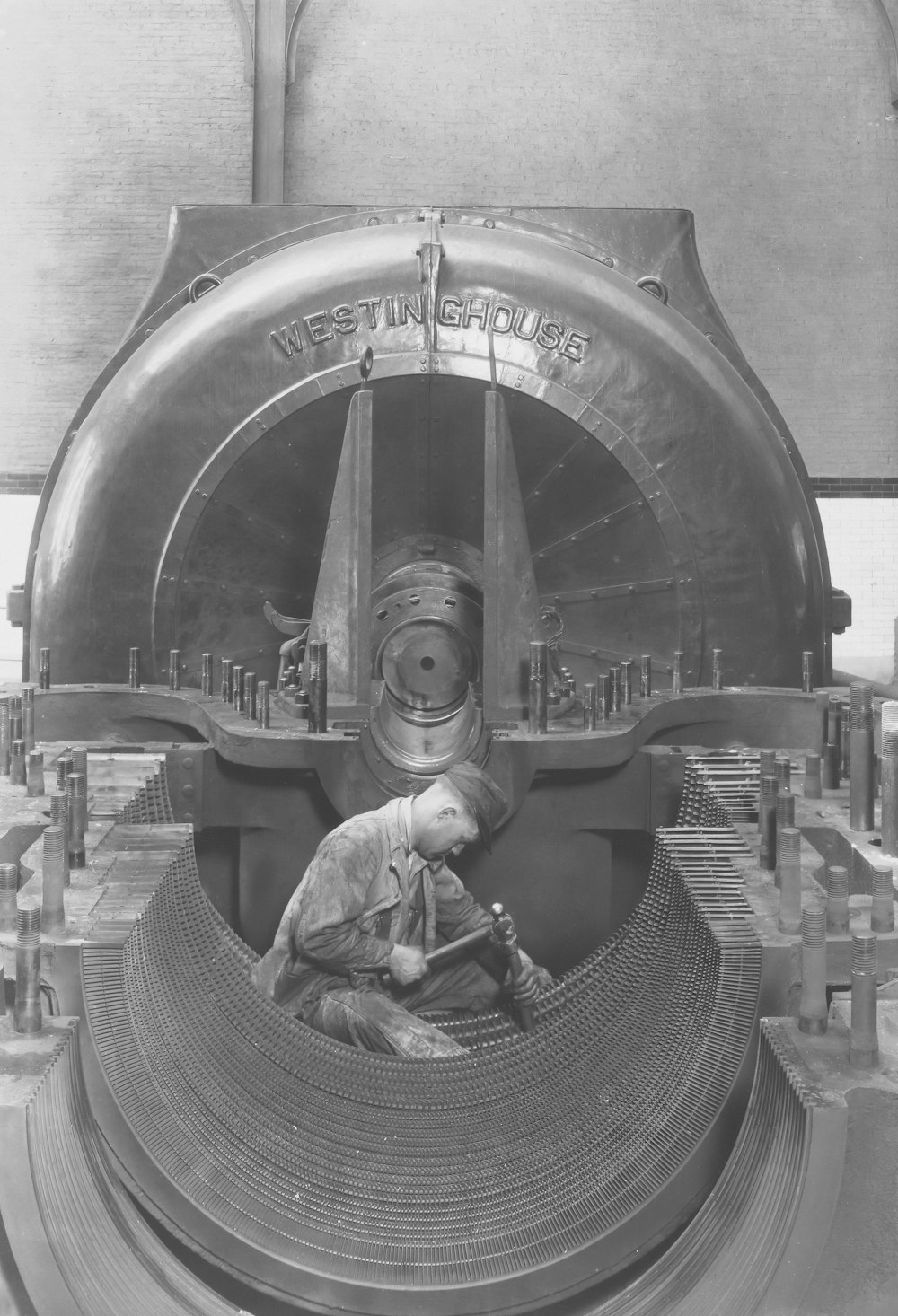 a man working on a machine in a factory