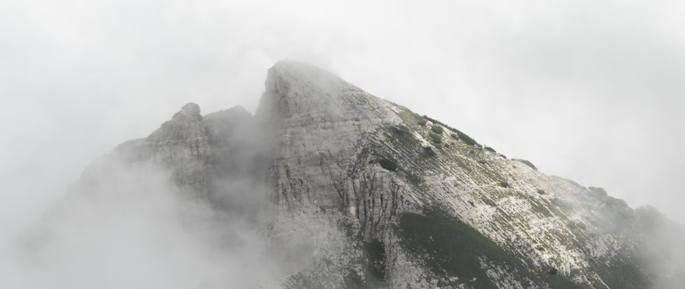 a very tall mountain covered in fog and clouds