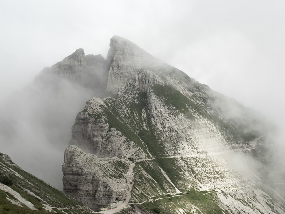 a very tall mountain covered in fog and clouds