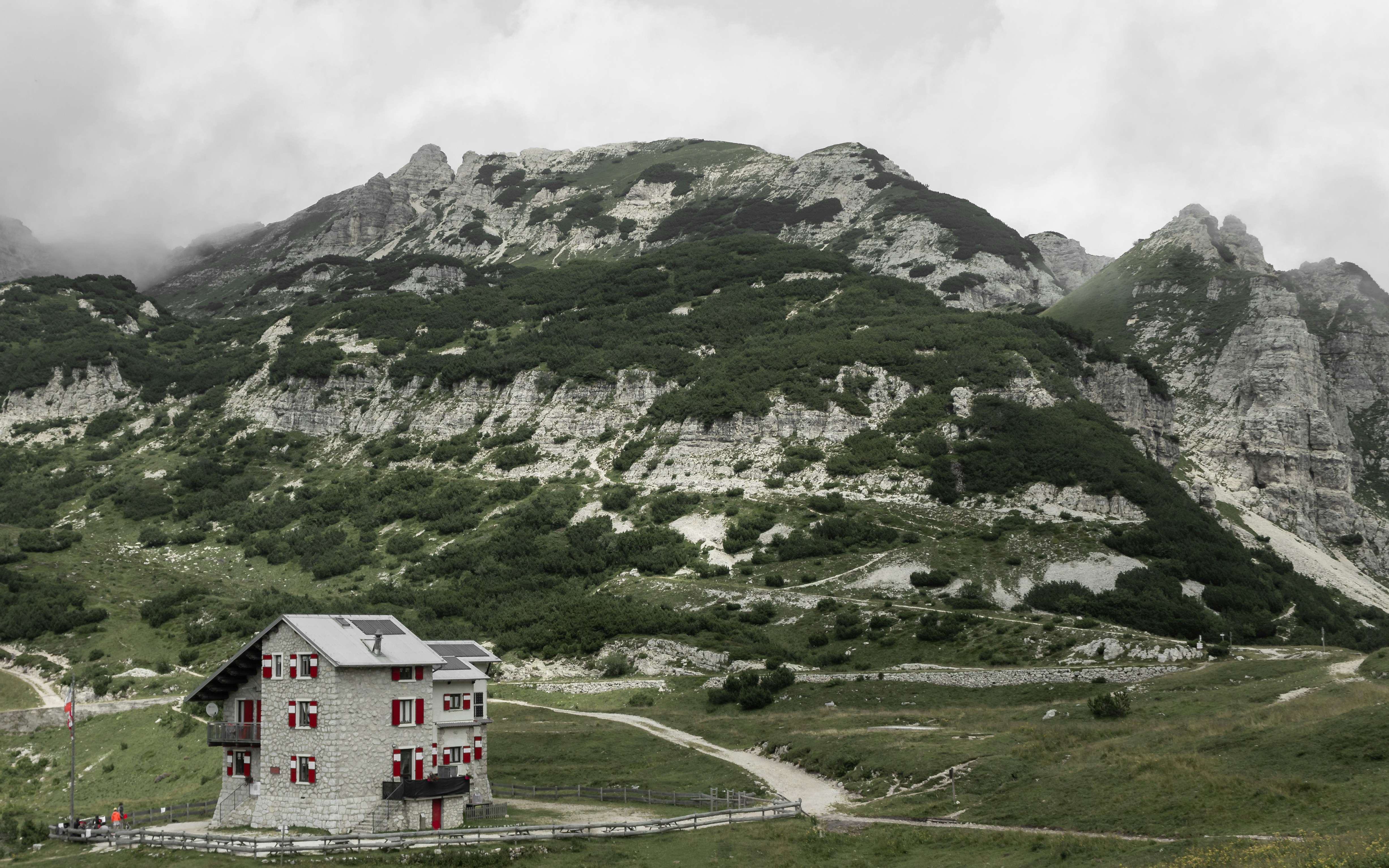 a house in the middle of a mountain range