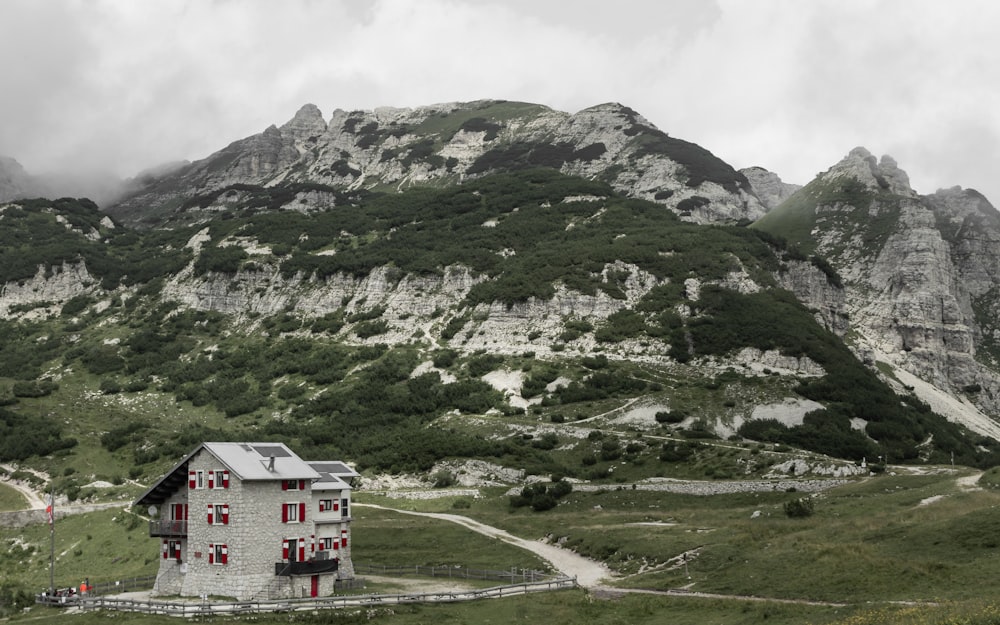 a house in the middle of a mountain range