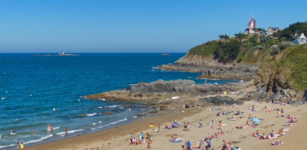 a group of people on a beach near the ocean