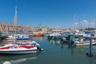 A picturesque harbor with boats docked and a clear blue sky.
