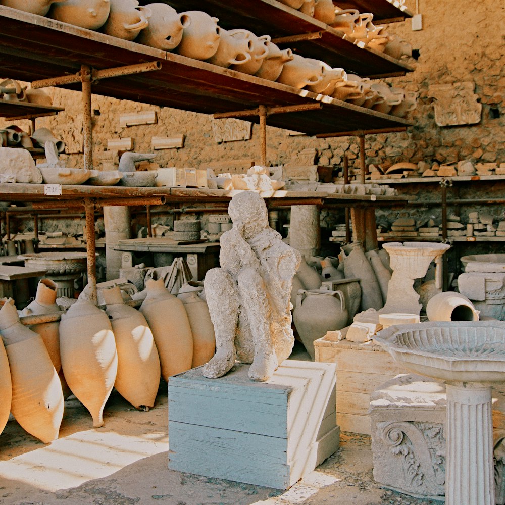 a room filled with lots of vases and statues