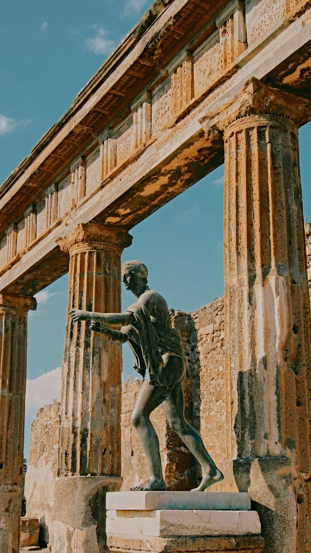 a statue of a man standing next to a building