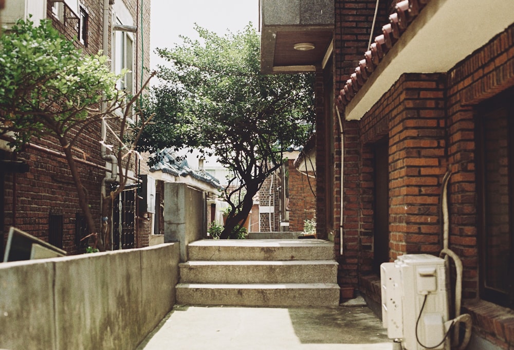 a narrow alleyway with a telephone on the side