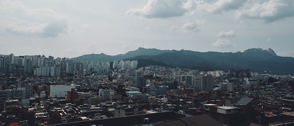 a view of a city with mountains in the background