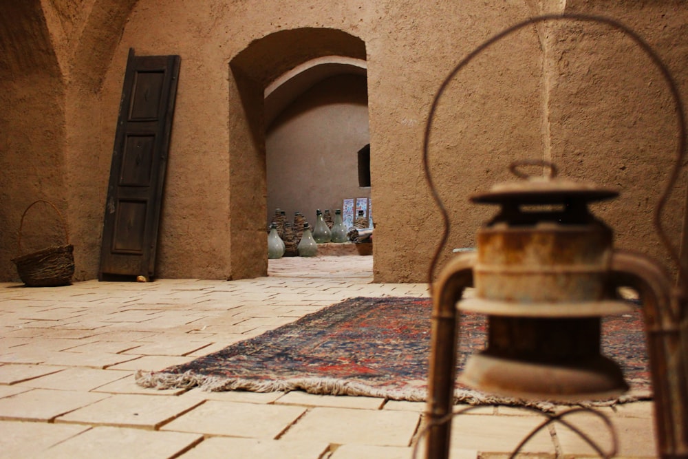 a door is open to a courtyard with a rug on the floor