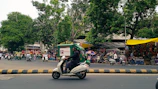 A busy Bengaluru street scene with eco-friendly packaging products being used by local vendors.