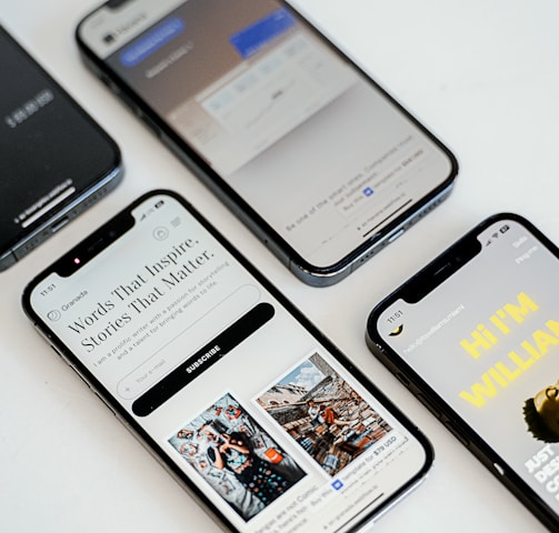 three different cell phones sitting next to each other