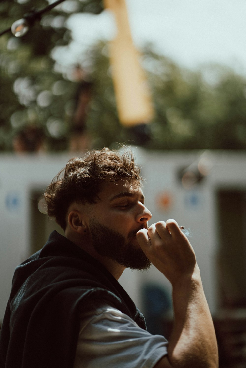 a man with a beard is smoking a cigarette