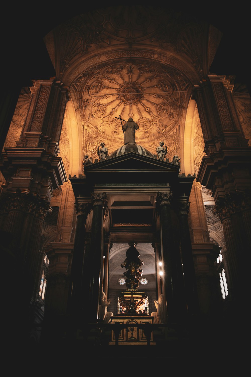 a church with a statue on the top of it