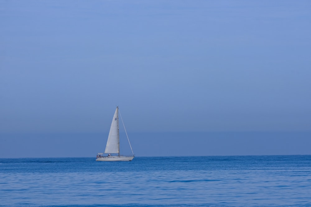 a sailboat in the middle of the ocean