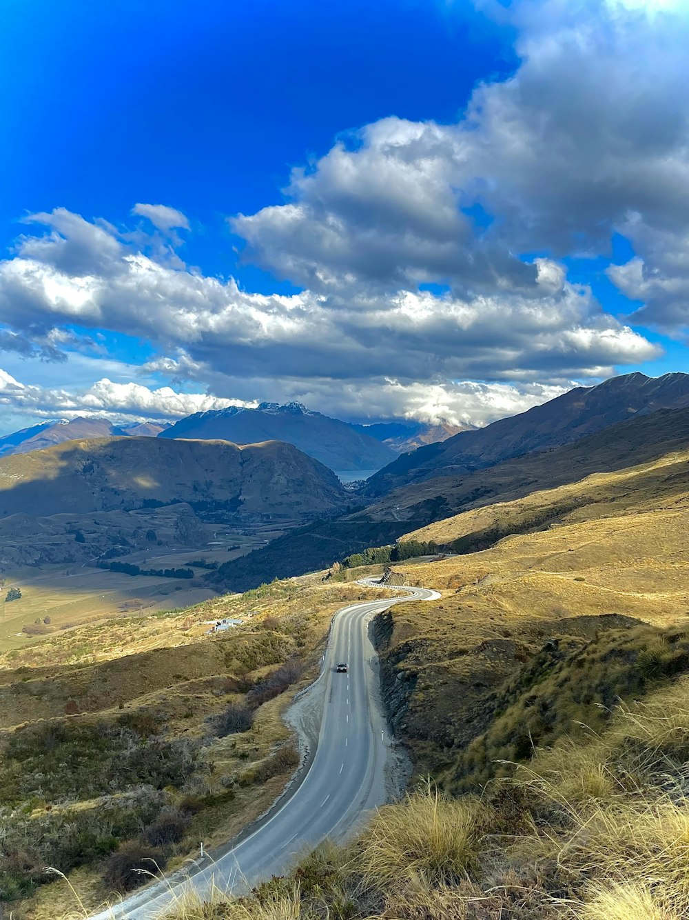 a car driving down a dirt road in the mountains