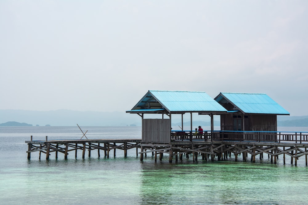 a pier with a couple of huts on it