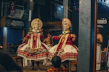 A traditional Kathakali dancer in vibrant costume and makeup performing in Kerala