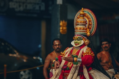 a man dressed in a colorful costume standing next to other men
