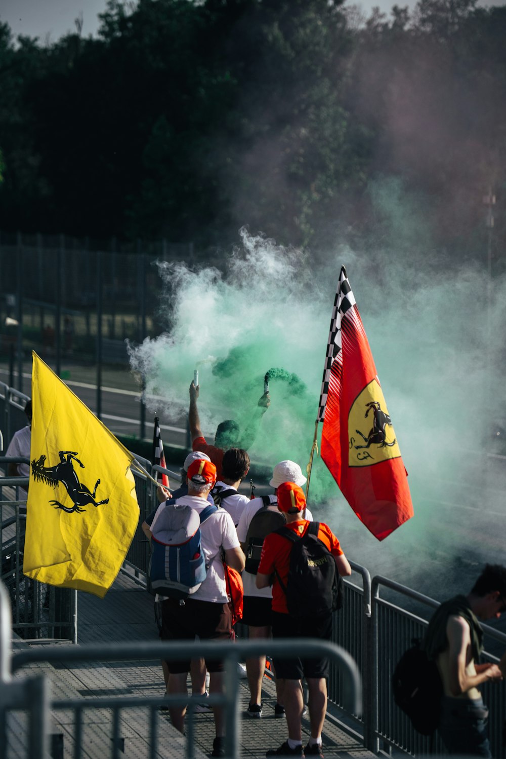 a group of people standing next to each other holding flags