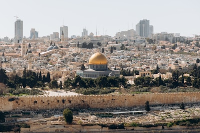 A peaceful view of the Jerusalem skyline at sunset with the golden Dome of the Rock.