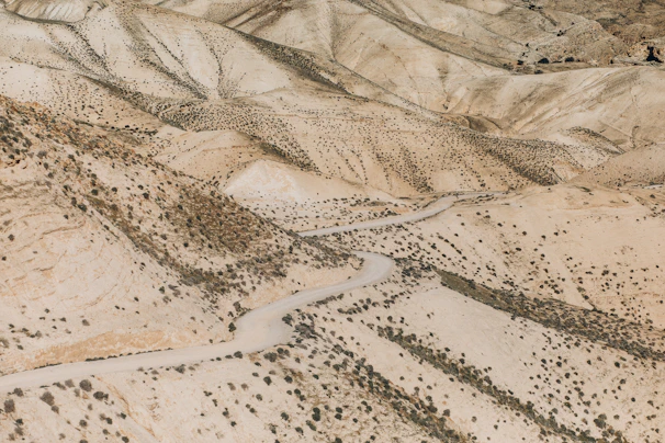 A dusty dirt road winding through raw land parcels in Dateland.