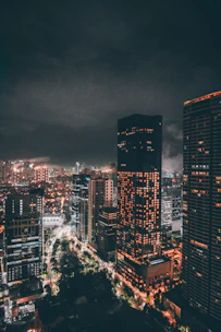 A bustling cityscape at night with illuminated skyscrapers and lively streets