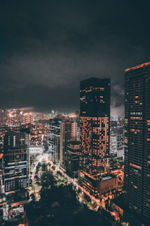 A bustling cityscape at night with illuminated skyscrapers and lively streets