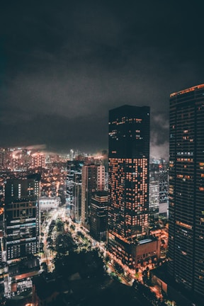 Bustling cityscape of Dubai at night with illuminated skyscrapers and lively streets