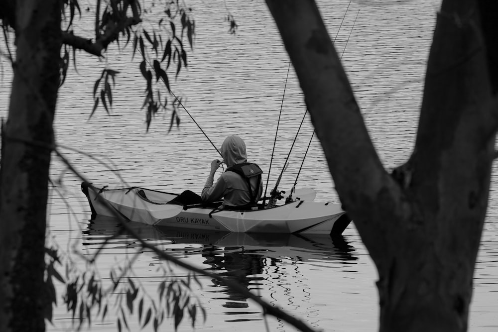 a man in a canoe with a fishing rod