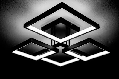 a black and white photo of a square light fixture