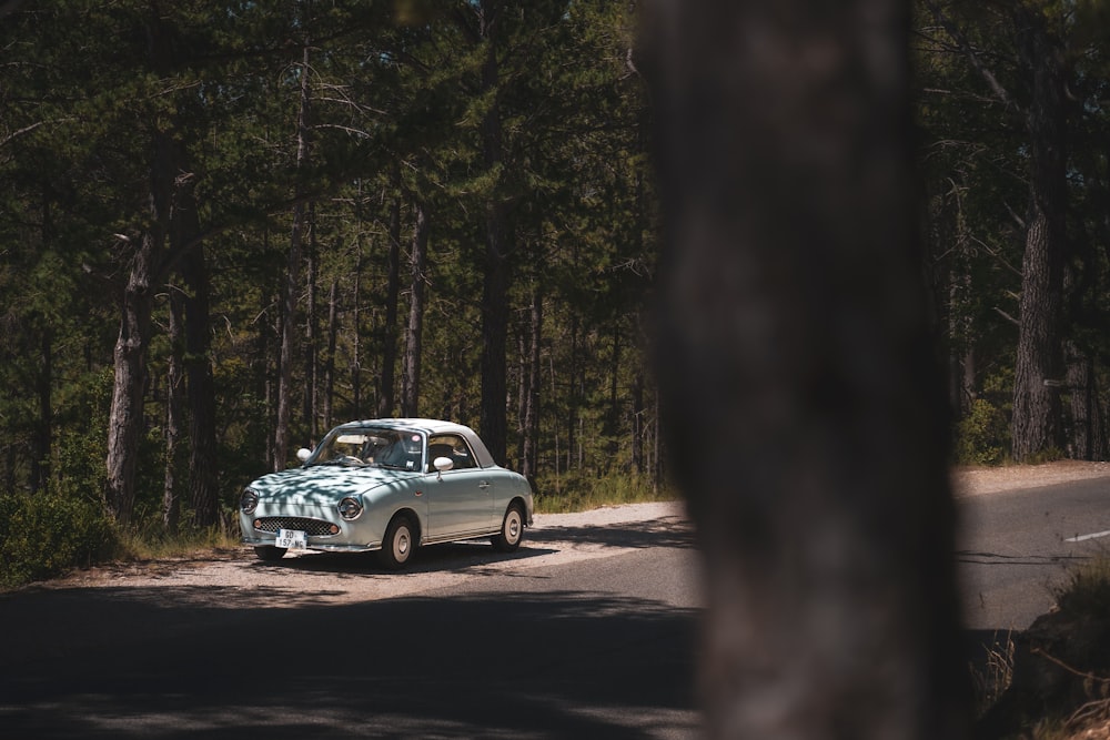 an old car is parked on the side of the road