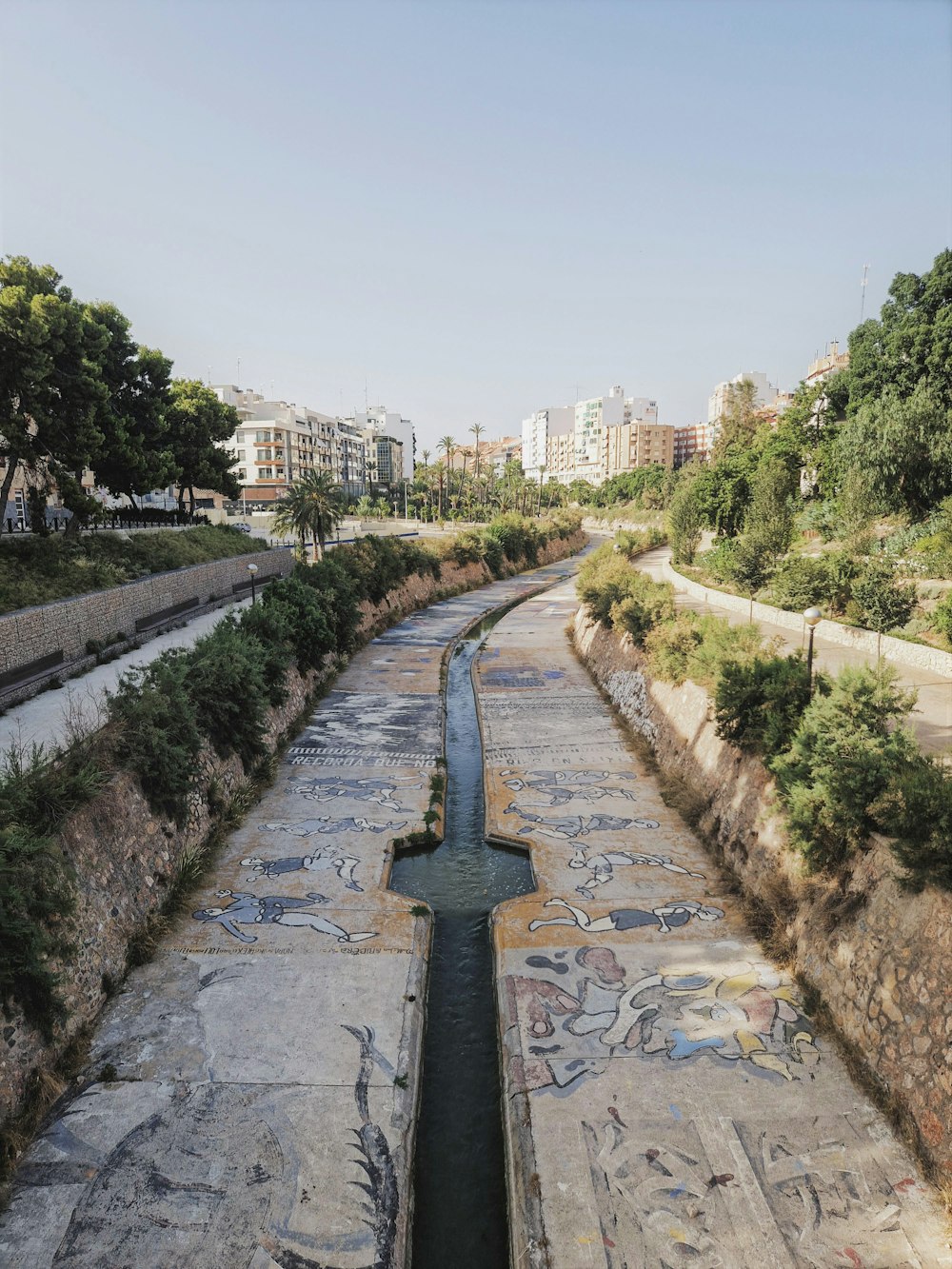 a river running through a city next to tall buildings