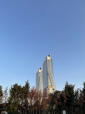 A sleek vertical shot of BPTP Skynest’s twin towers reaching into a clear blue sky.