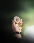 Hands gently holding a compass, representing guidance and direction.