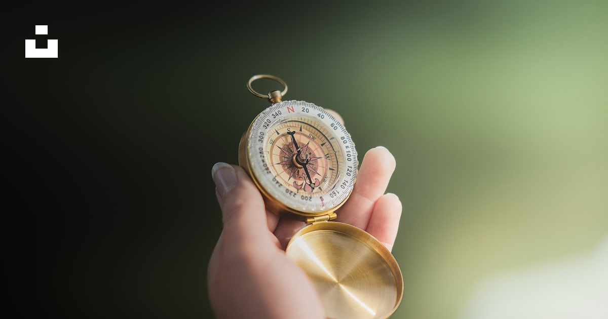 A person holding a compass in their hand photo – Free Hand Image on ...